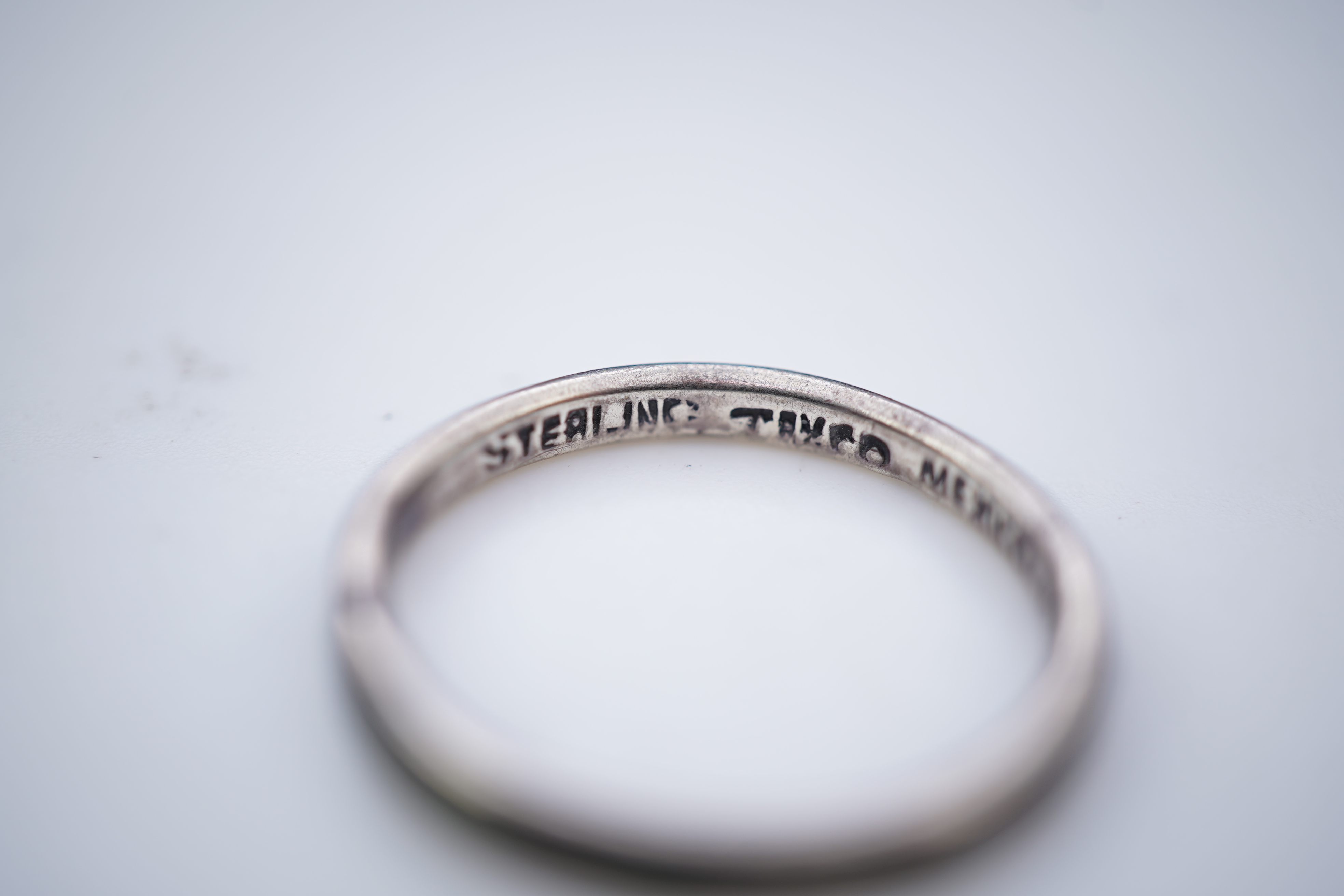 A collection of silver jewels, comprising: a bangle; a chain necklace suspending two winding toothpicks, one with toothpick deficient; a rope twist chain; a pair of cufflinks with the initials DBH; a pendant of abstract